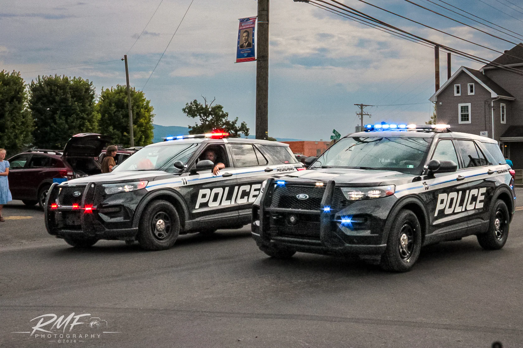 Two Pennsylvania police vehicles with emergency lights illuminated