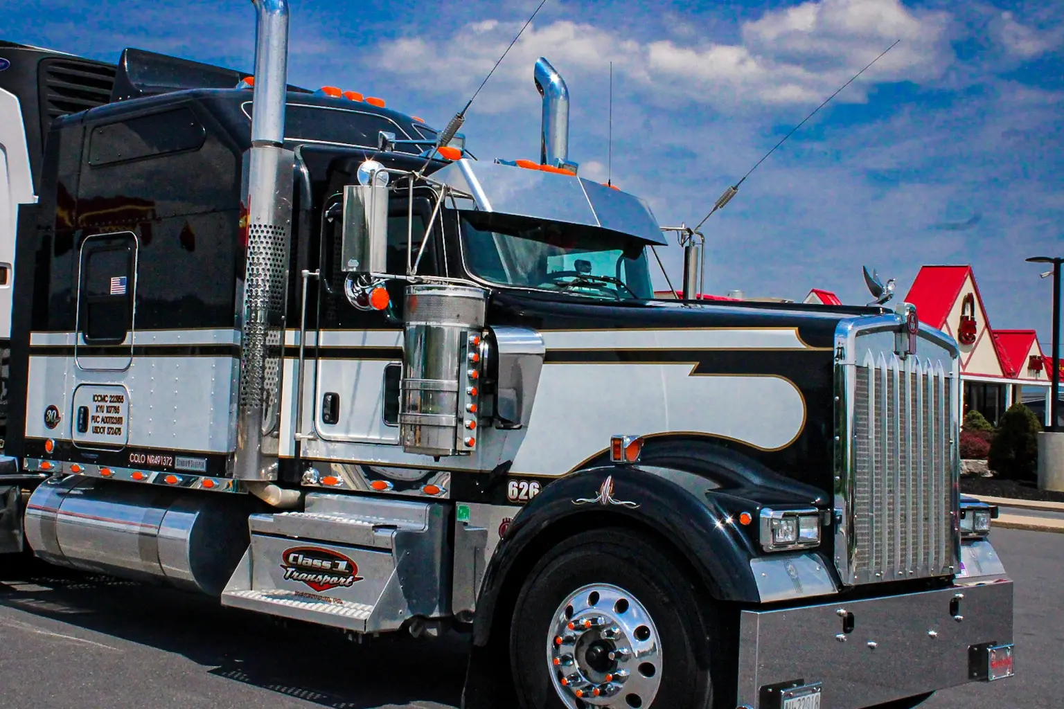 Black and silver long-haul truck photographed by RMF Photography