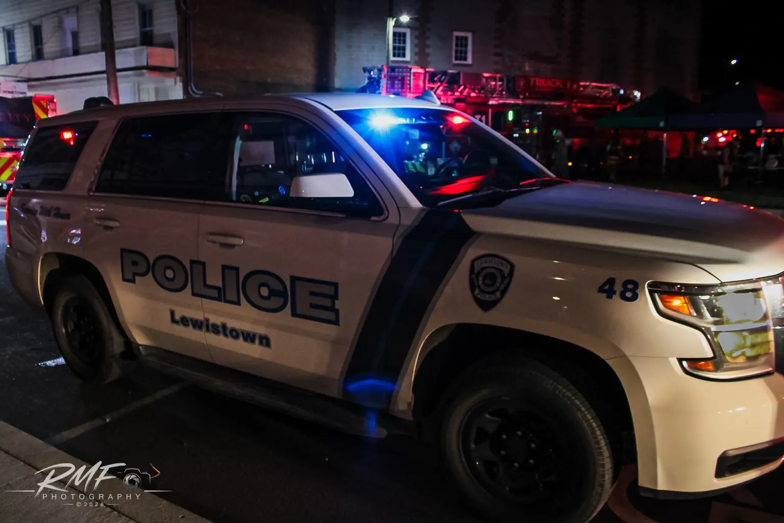Lewistown police vehicle with emergency lights illuminated
