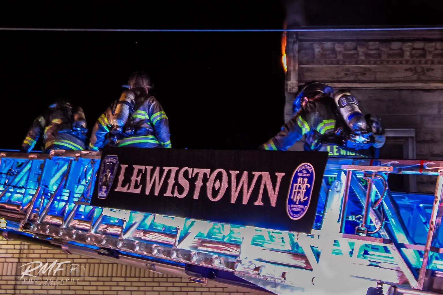 Lewistown firefighters working from an aerial ladder