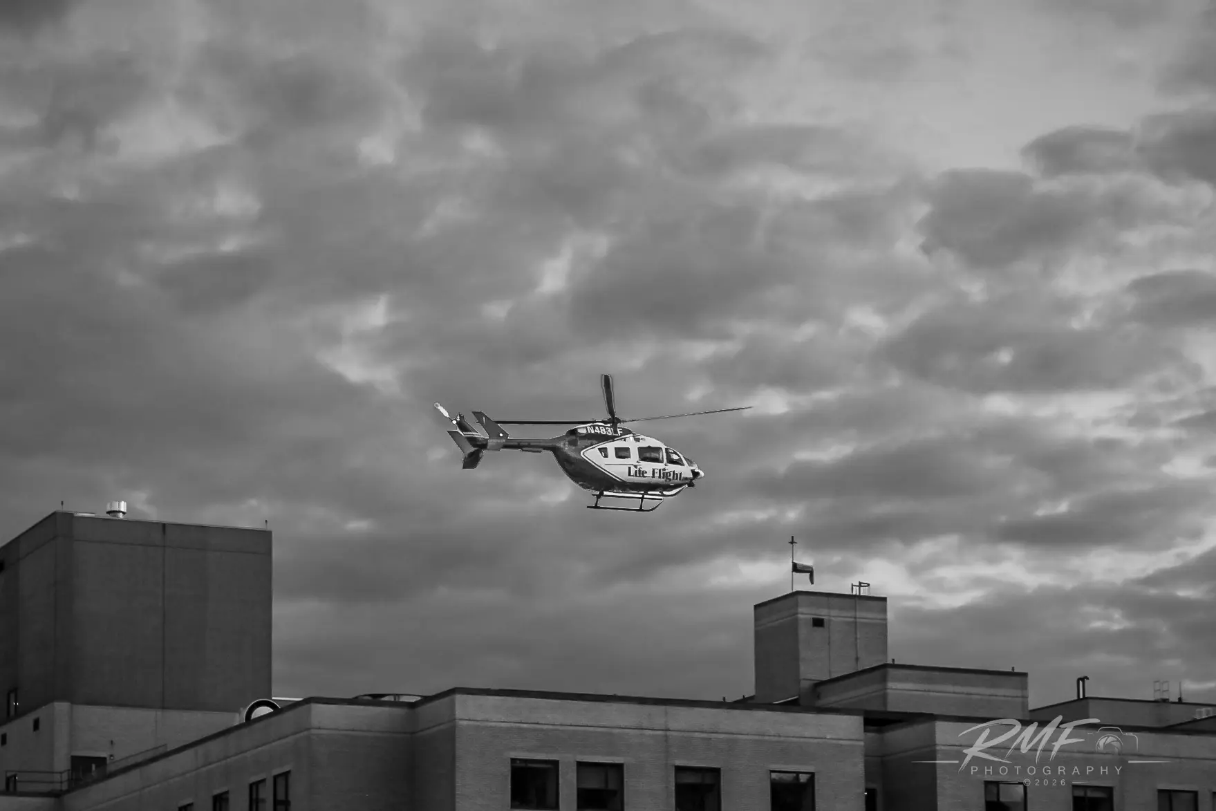 Black-and-white Geisinger Life Flight helicopter above the hospital