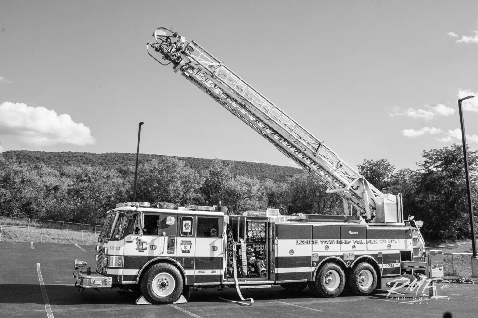 Black-and-white profile of Lewistown Fire Department Ladder 2 with its aerial raised