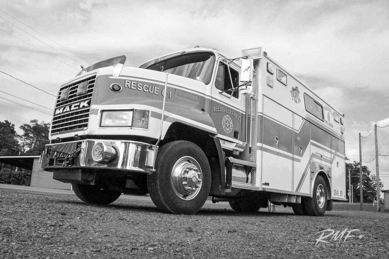 Low-angle black-and-white portrait of Reedsville Fire Company Rescue 6-1