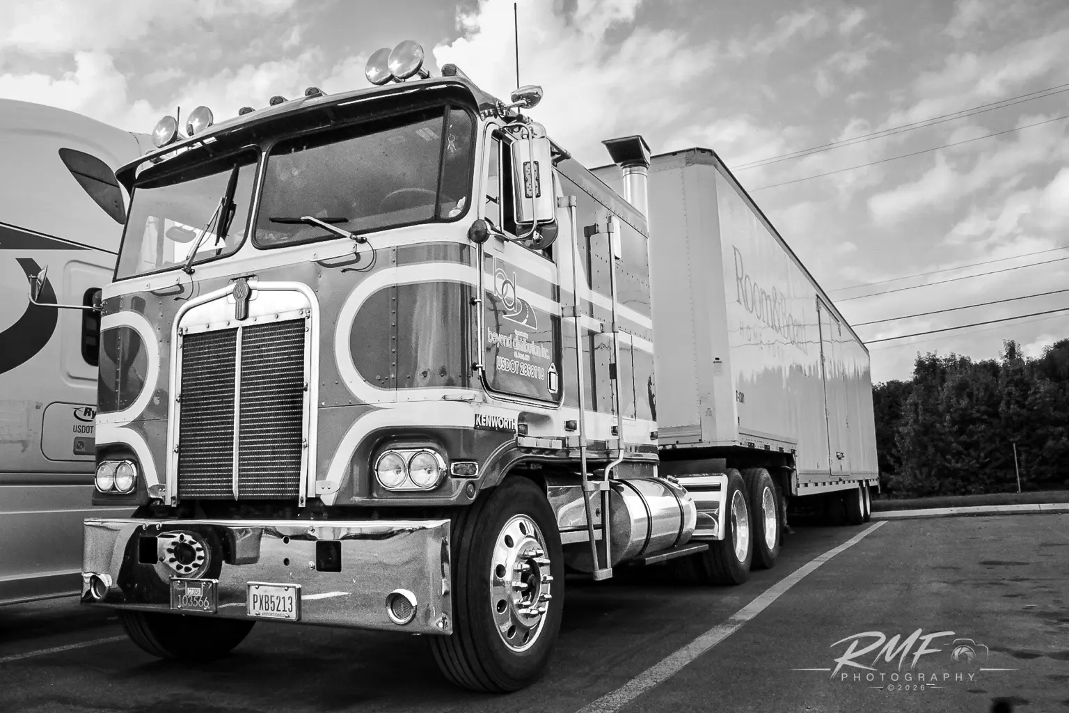 Black-and-white Kenworth cabover and trailer portrait
