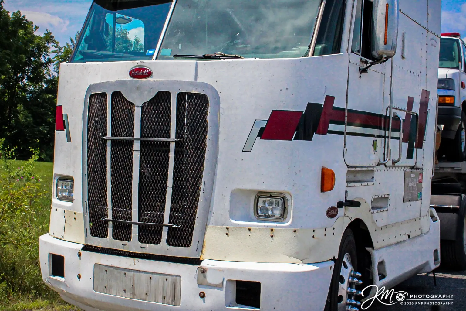 White Peterbilt cabover photographed up close